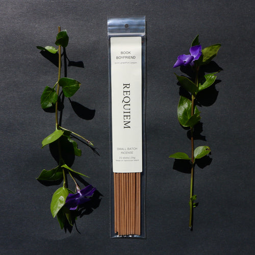 Requiem Incense Company Book Boyfriend incense sticks with green leaves and purple flowers on a dark background